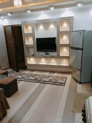 a living room with a tv and a refrigerator at flat in Hurghada Sheraton Street in Hurghada