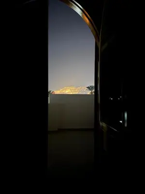 an open door to a room with a view of a mountain at Pharaohs Apartments - Panoramic Fourth Floor Apartment in Luxor
