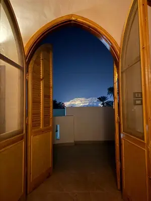 an archway leading into a room with a view at Pharaohs Apartments - Panoramic Fourth Floor Apartment in Luxor