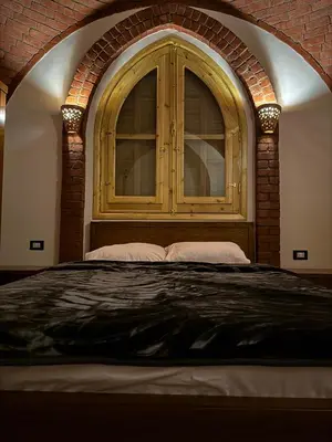 a bedroom with a large bed with a window at Pharaohs Apartments - Panoramic Fourth Floor Apartment in Luxor
