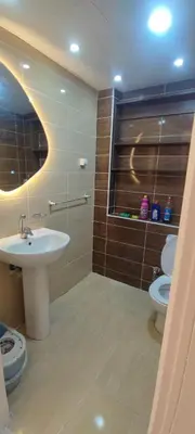a bathroom with a sink and a toilet at Ezz in Hurghada