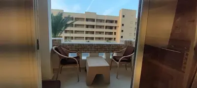 a room with a table and chairs and a building at Ezz in Hurghada