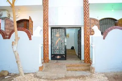 a door with a painting on it in a building at Aisha Guest House And Restaurant in Al Aqālitah