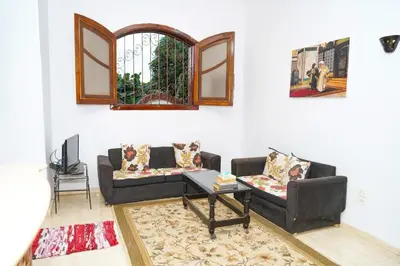 a living room with two couches and a table at Aisha Guest House And Restaurant in Al Aqālitah