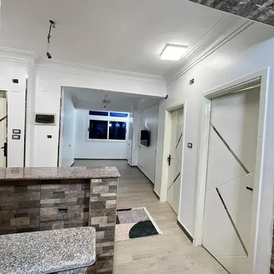a hallway of a home with white walls and a door at FUN MBASSY DELUXE APARTMENT ASWAN down town in Aswan