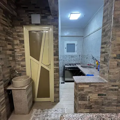 a kitchen with a yellow door and a sink at FUN MBASSY DELUXE APARTMENT ASWAN down town in Aswan