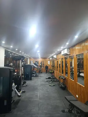 a gym with rows of exercise equipment in a room at Sea La Vie Furnteched, Central, Beach Front, Free WIFI in Hurghada