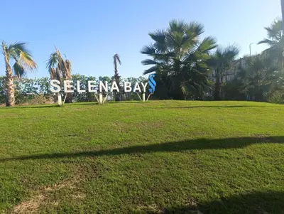 a large sign in a park with palm trees at Selena Bay in Hurghada