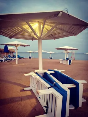 a beach with chairs and umbrellas on the beach at Selena Bay in Hurghada