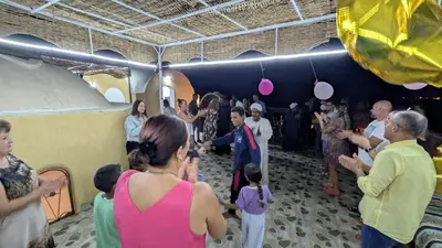 a group of people standing in a room with a crowd at Karima's house B in Al Aqālitah