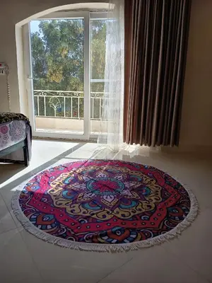 a rug on the floor in front of a window at Karima's house B in Al Aqālitah
