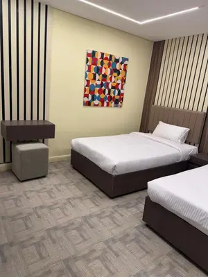 a bedroom with two beds and a painting on the wall at CBA - Cavalli Boutique Apartments in Hurghada