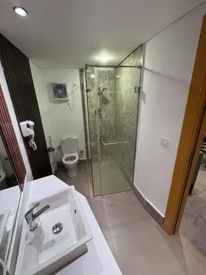 a bathroom with a shower and a sink and a toilet at CBA - Cavalli Boutique Apartments in Hurghada