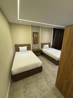 two beds in a hotel room with two beds sidx sidx sidx at CBA - Cavalli Boutique Apartments in Hurghada