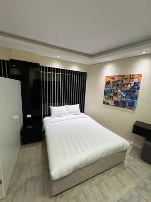 a bedroom with a large white bed in a room at CBA - Cavalli Boutique Apartments in Hurghada