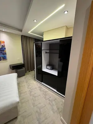 a living room with a large entertainment center at CBA - Cavalli Boutique Apartments in Hurghada