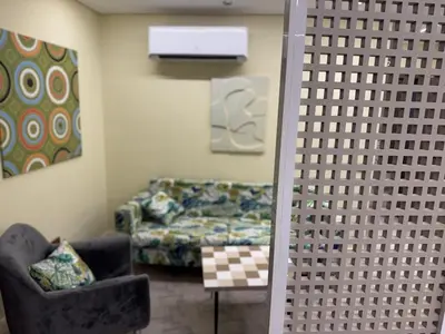 a living room with a couch and a chair at CBA - Cavalli Boutique Apartments in Hurghada