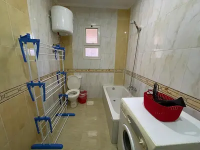 a bathroom with a tub and a toilet and a sink at Family-Friendly Studio, Beach and Pools Access in Hurghada