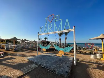 a beach with a sign that reads i ve karma at Family-Friendly Studio, Beach and Pools Access in Hurghada