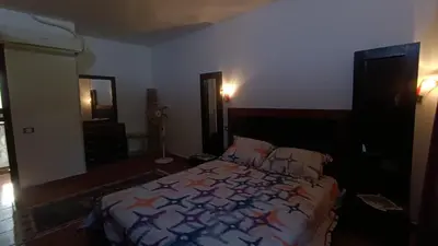 a bedroom with a bed with a colorful blanket at Cozy Chalet In Stella Makadi Beach Resort Hurghada in Hurghada