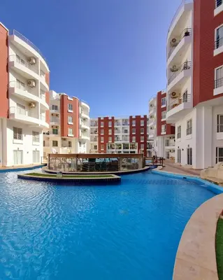 a swimming pool in the middle of some buildings at Aqua Palms Resort Hurghada in Hurghada
