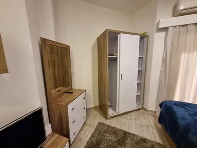 a bedroom with a mirror and a dresser and a bed at Aqua Palms Resort Hurghada in Hurghada