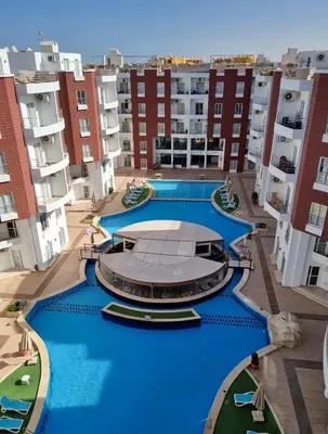 an aerial view of an apartment complex with a large swimming pool at Aqua Palms Resort Hurghada in Hurghada