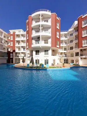 a swimming pool in front of some apartment buildings at Aqua Palms Resort Hurghada in Hurghada