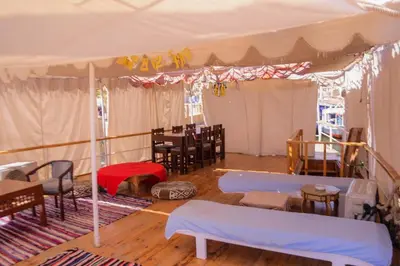 a room with a tent with tables and chairs at Water Lily in Luxor