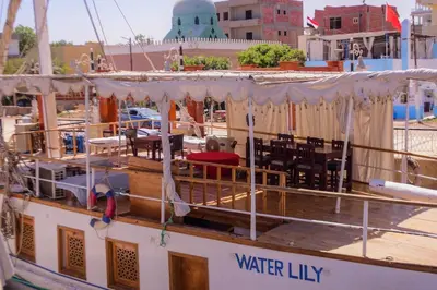 a boat with tables and chairs on the deck at Water Lily in Luxor