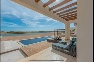 a villa with a swimming pool and a patio at Stunning Villa with breathtaking golf & lake view in Hurghada