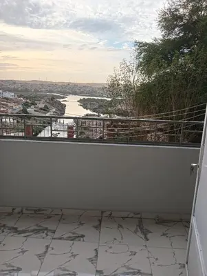 a balcony with a view of a river at noreno house in Shellal