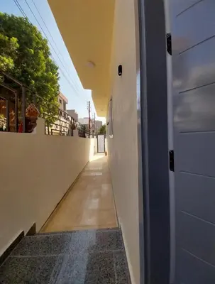 a hallway of a house with a door and a sidewalk at Desert Daisy in Luxor