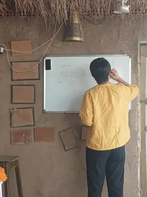 a man writing on a whiteboard on a wall at Soul house in Aswan