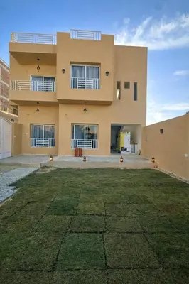 a building with a large yard in front of it at Habu Palace home in Luxor
