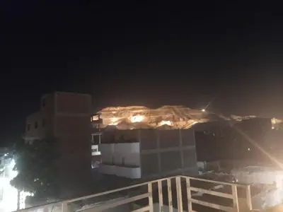 a view of a city at night with buildings at Habu Palace home in Luxor