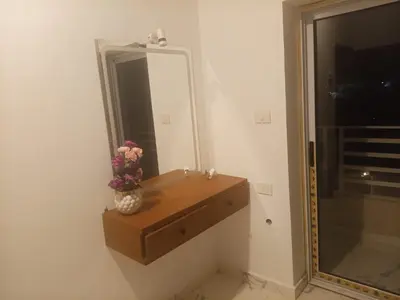 a bathroom with a mirror and a vase of flowers at Habu Palace home in Luxor