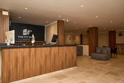 a hotel lobby with a bar and a desk at The Fit Stop Hostel in Hurghada