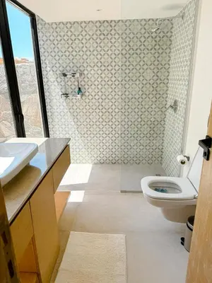a bathroom with a white toilet and a shower at Amazing 4 BR Villa in Soma Bay Movin Stay in Hurghada