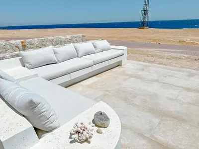 a white couch sitting on top of a patio at Amazing 4 BR Villa in Soma Bay Movin Stay in Hurghada