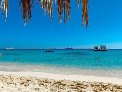 a beach with some boats in the water at Amazing 4 BR Villa in Soma Bay Movin Stay in Hurghada