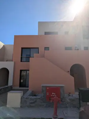a building with a red fire hydrant in front of it at EL GOUNA Boho Beach Chalet with pool access in Hurghada