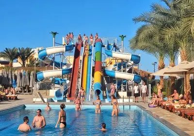 a group of people in a pool at a water park at Fanadir Bay Beach Resort & Aqua Park in Hurghada