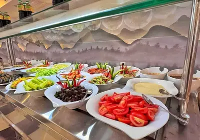 a buffet line with many plates of food on it at Fanadir Bay Beach Resort & Aqua Park in Hurghada