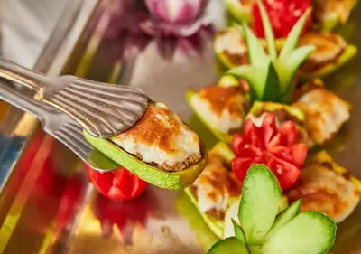 a fork with food on a plate with flowers at Fanadir Bay Beach Resort & Aqua Park in Hurghada