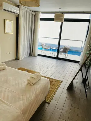 a bedroom with a bed and a view of the ocean at 2BR Ground Floor Apartment with Heated Pool in Bali El Gouna in Hurghada