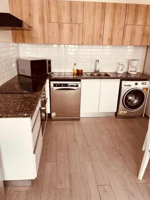 a kitchen with a sink and a dishwasher at 2BR Ground Floor Apartment with Heated Pool in Bali El Gouna in Hurghada