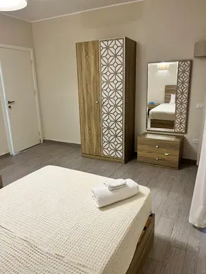 a bedroom with a bed and a large mirror at 2BR Ground Floor Apartment with Heated Pool in Bali El Gouna in Hurghada