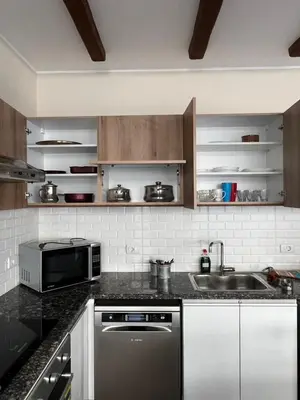 a kitchen with a sink and a microwave at 2BR Ground Floor Apartment with Heated Pool in Bali El Gouna in Hurghada