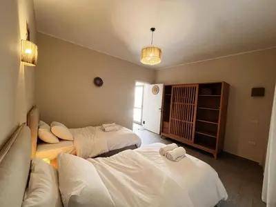 a room with two beds and a couch at 2BR Ground Floor Apartment with Heated Pool in Bali El Gouna in Hurghada